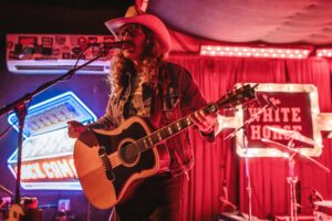 Performer on stage at The White Horse Austin