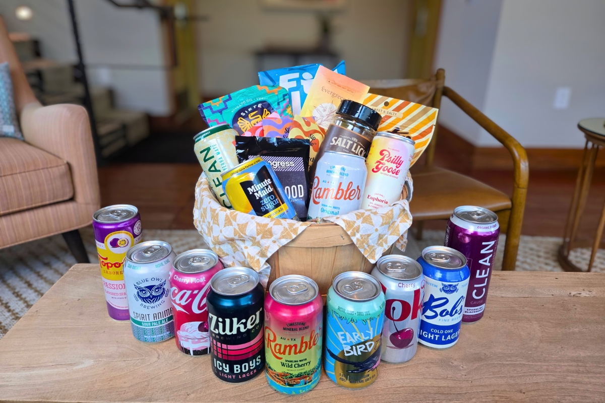 Heywood Hotel guests receive a free welcome basket for ACL Fest. The basket includes goodies from Blue Owl Brewing, Zilker Brewing Co., Rambler Sparkling Water, Coca-Cola, Austin Pretzel Co., Siete Foods, Salt Lick BBQ, FitJoy, Progress Coffee, Sip Solo, Evergreen Chai, CLEAN Cause, Yerba Mate, and Topo Chico