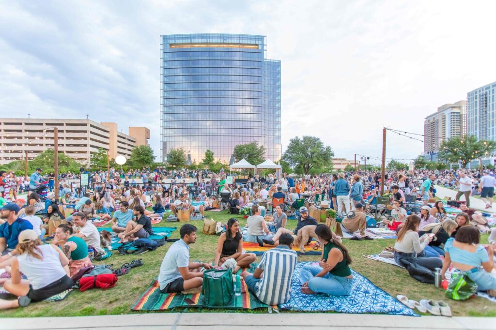 People sitting on picnic blankets at Austin's Pop-Up Picnic, an April event.