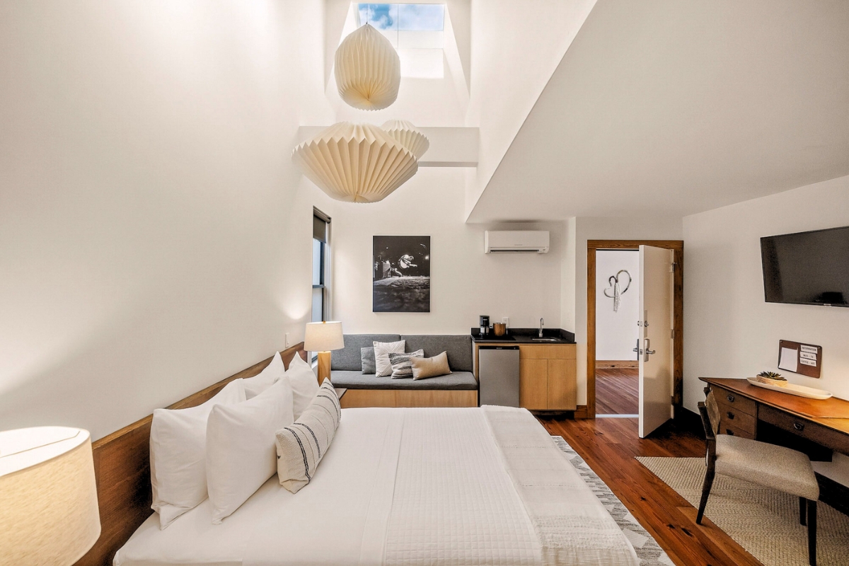 Queen Deluxe room at the Heywood Hotel in Austin, with longleaf pine floors and a 28-foot skylit ceiling