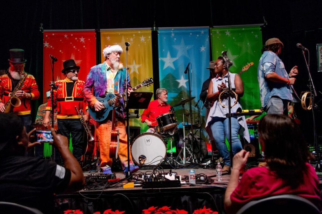 Performers on stage at Armadillo Christmas Bazaar, an Austin holiday market.