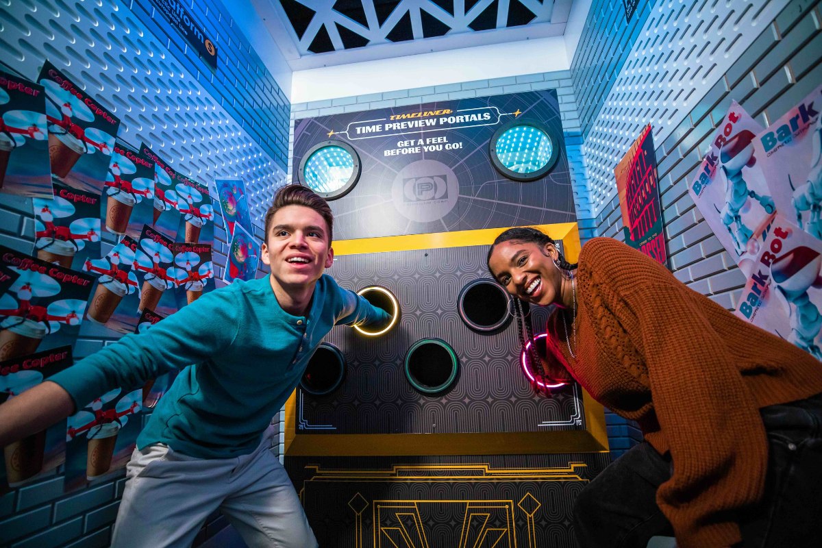 Two guests laughing and posing inside The Escape Game Austin's Timeliner escape room, one of the most popular indoor activities in Austin.